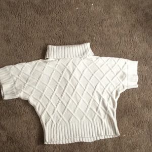 Khaki turtleneck sweater with 3/4 sleeves.